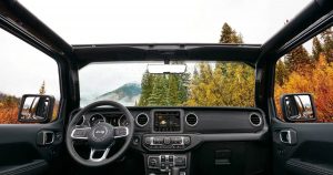 View from interior of a 2018 Jeep Wrangler looking at a forest