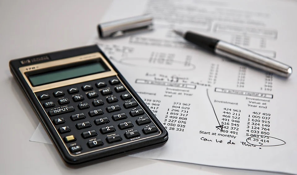 A calculator and finances on a table